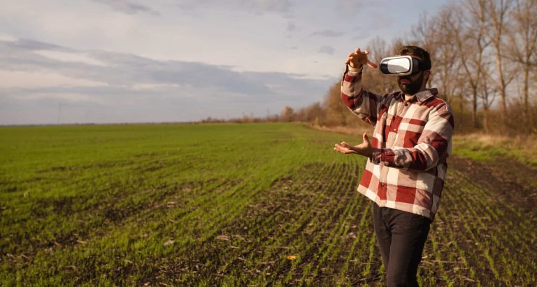 Man on a field wearing VR glasses