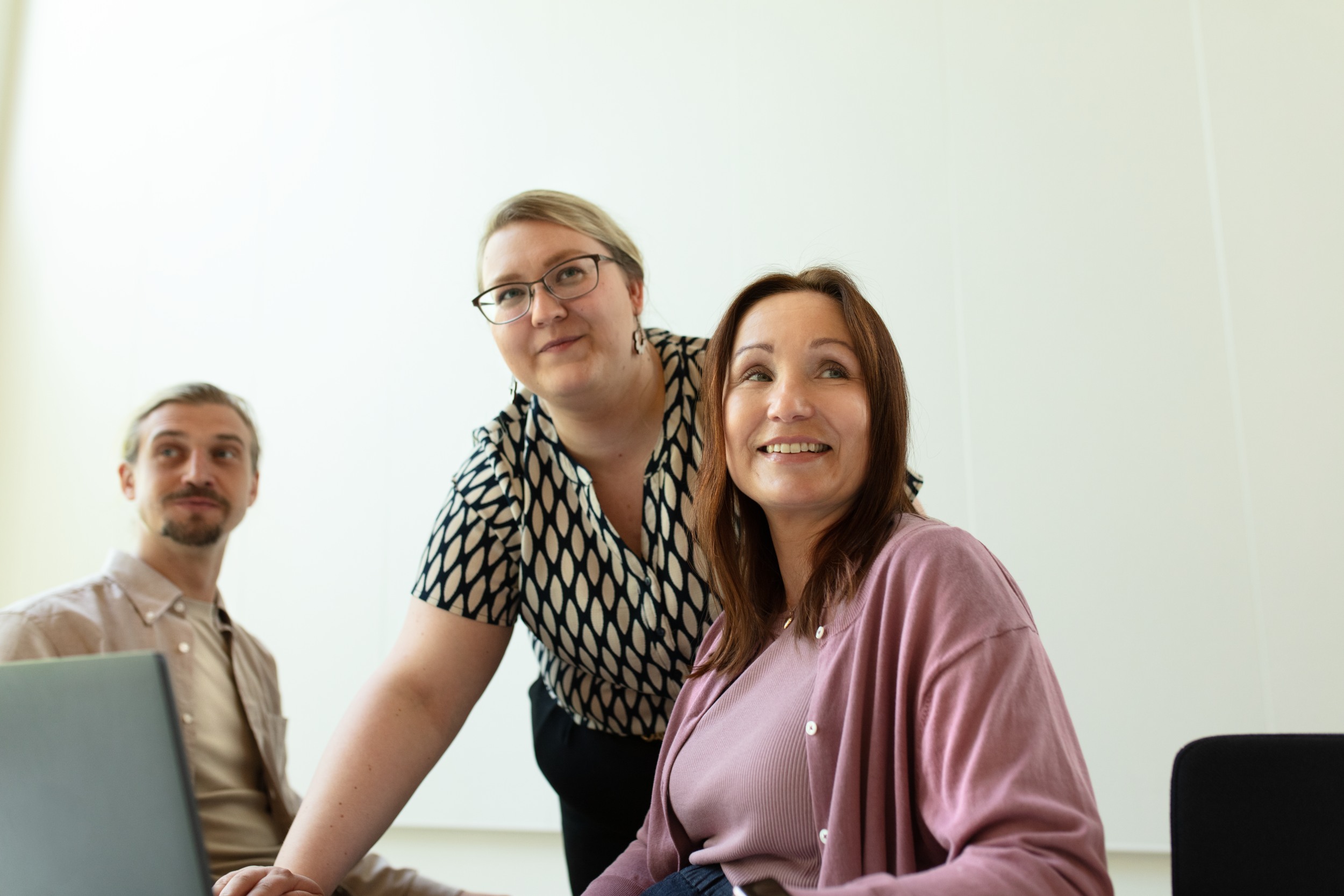 A man and two women are studying together.