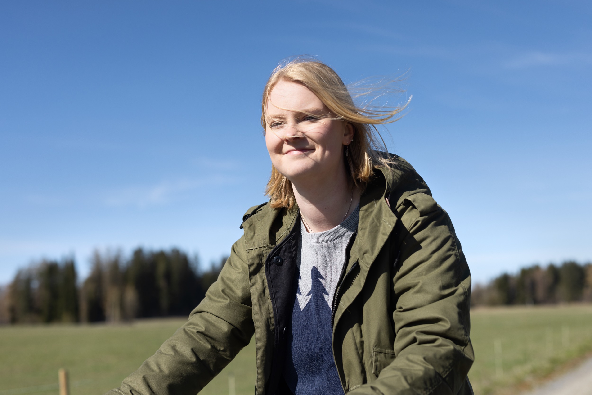 A young person rides a cycle in a sunny weather.