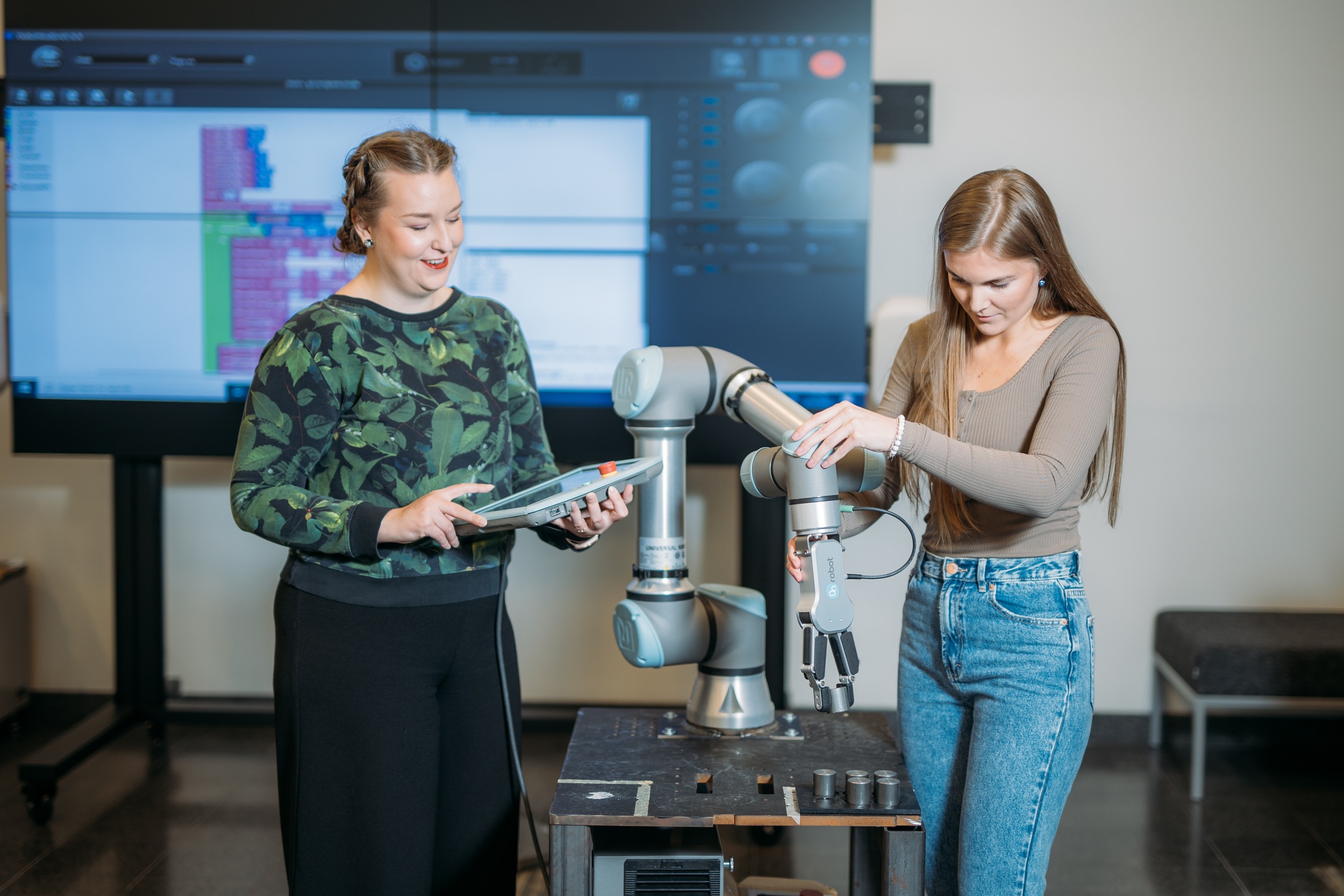 Two students working with a robot