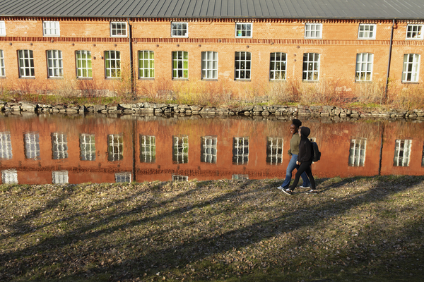 Two persons walking on campus