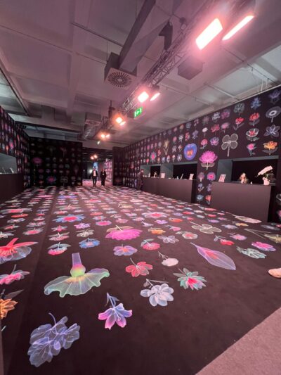 A dark hall with floral prints on the floor and walls.
