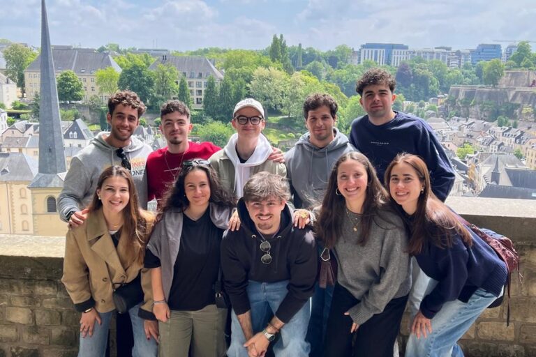Group of students posing. At the background there's the city of Eindhoven.