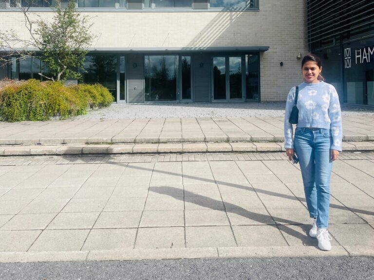 International Business student Hansani standing in front of the HAMK Valkeakoski campus.