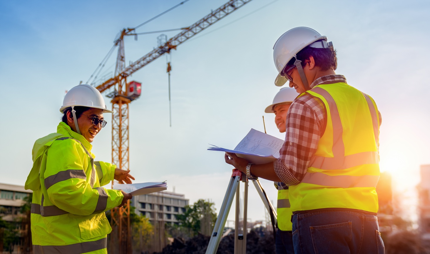 Construction engineers discussion with architects at construction site or building site of highrise building with Surveying for making contour plans is a graphical representation of the lay in land.
