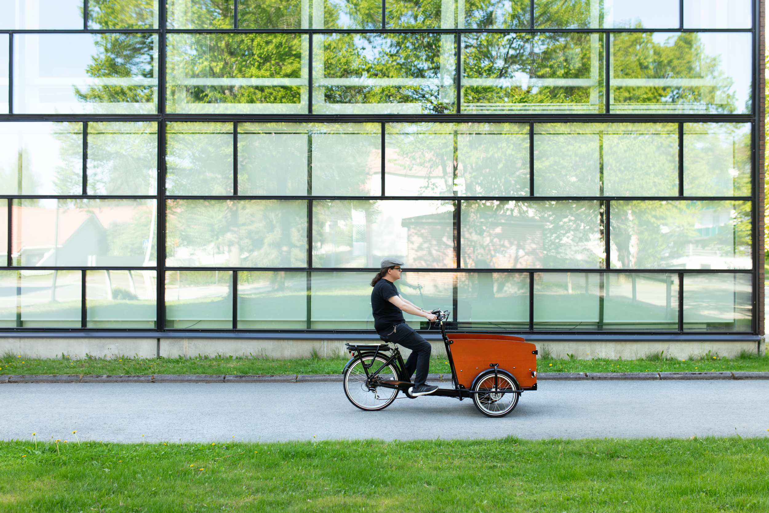Person biking in green scenery.